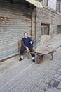 Female elderley outside on a chair, Qingdao, China